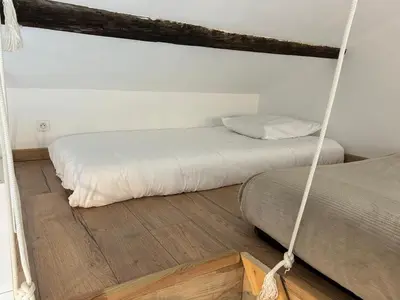 a bedroom with two beds and a swing at Studio cosy avec mezzanine in Salon-de-Provence