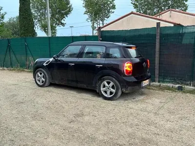 a small black car parked in a dirt lot at Studio cosy avec mezzanine in Salon-de-Provence