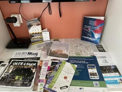 a table with a bunch of publications on it at Studio cosy avec mezzanine in Salon-de-Provence