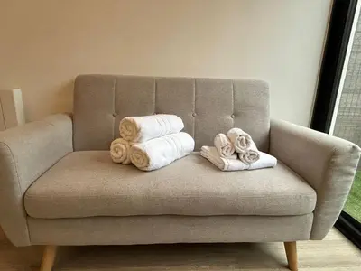 a couch with towels and towels on it at Studio cosy avec mezzanine in Salon-de-Provence