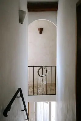 a staircase in a white room with a window at Charming Village House in the Heart of Isle-sur-la-Sorgue in LʼIsle-sur-la-Sorgue