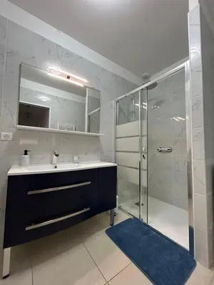a bathroom with a sink and a glass shower at Villa Mirabelle 4 personnes in Châteauneuf-de-Gadagne