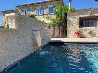 a pool of water in front of a house at Farmhouse in Carpentras with Pool in Carpentras