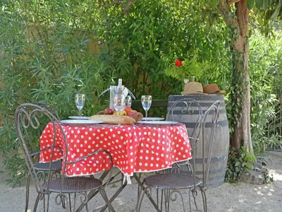 a table with a red and white polka dot table cloth at Farmhouse in Carpentras with Pool in Carpentras