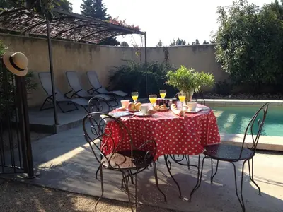 a table with a red and white polka dot table cloth at Farmhouse in Carpentras with Pool in Carpentras