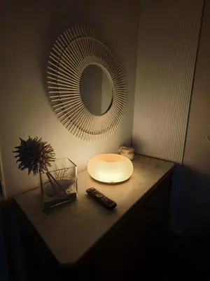 a table with a mirror and a remote control on it at chambre d'hote de charme 