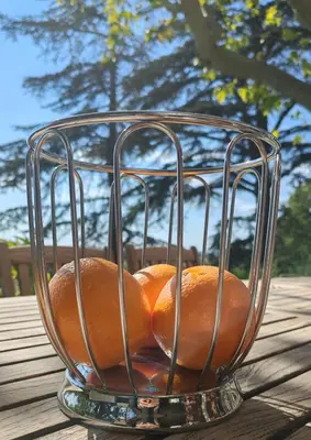 a bowl of oranges sitting on top of a table at chambre d'hote de charme 