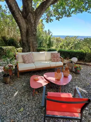 a couch and two chairs and a table and a tree at chambre d'hote de charme 