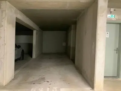 an empty garage with a car parked in it at Logement cosy climatisé avec parking in Aix-en-Provence