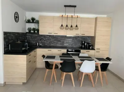 a kitchen with a table and some chairs in it at Logement cosy climatisé avec parking in Aix-en-Provence