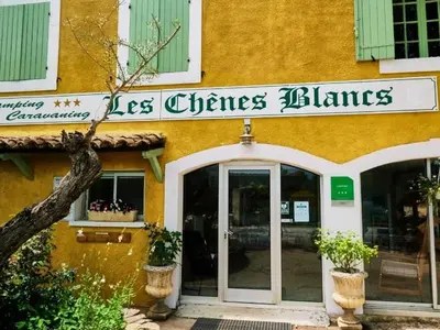 a store with a sign on the side of a building at Camping maeva Escapades Le Domaine des Chênes Blancs in Croagnes