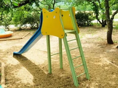 two chairs sitting on a slide at a playground at Camping maeva Escapades Le Domaine des Chênes Blancs in Croagnes