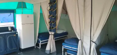 a room with two chairs in a tent at Camping maeva Escapades Le Domaine des Chênes Blancs in Croagnes