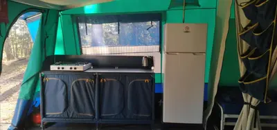 an interior view of an rv with a stove and refrigerator at Camping maeva Respire La Vallée Heureuse in Orgon