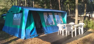 a blue and green tent with white chairs and a table at Camping maeva Respire La Vallée Heureuse in Orgon