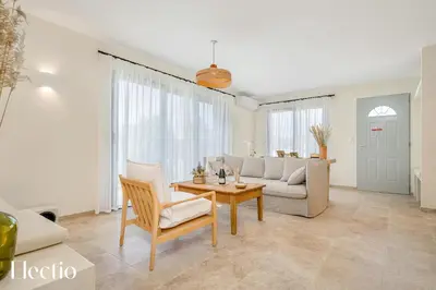 a living room with a couch and a table at Villa Oliveda - Piscine & Salon Cinéma in Lourmarin