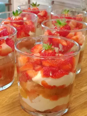a group of glasses of dessert with strawberries in them at Roulotte Karlotte in Pernes-les-Fontaines