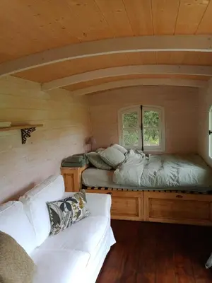 a room with two beds and a couch in a cabin at Roulotte Karlotte in Pernes-les-Fontaines
