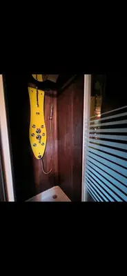 a guitar hanging on a wall next to a window at nuitée à la ferme in Jouques