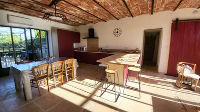 a kitchen and dining room with a table and chairs at La Grange des Joumillons in Saint-Saturnin-les-Apt