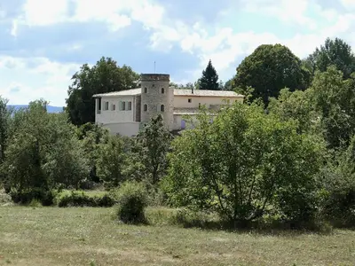 a building in the middle of a field with trees at La Grisonne - Gîte Camus in Revest-du-Bion