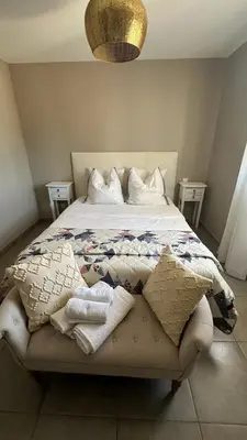 a bedroom with a bed with pillows on it at Magnifique villa familiale avec piscine in Caumont-sur-Durance
