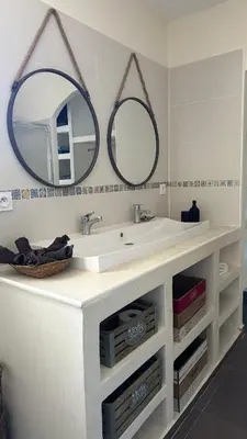 a bathroom with two mirrors above a white sink at Magnifique villa familiale avec piscine in Caumont-sur-Durance
