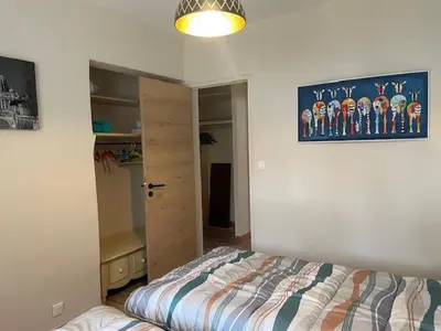 a bedroom with a bed and a picture on the wall at Gîte de L'Embuissonnade in Montfuron