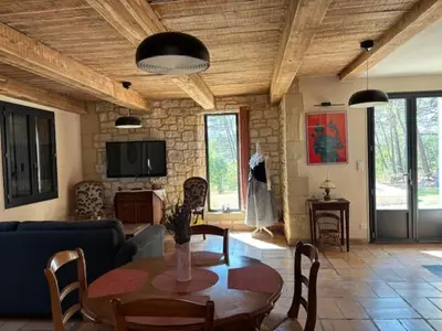 a living room with a table and a couch at Gîte de L'Embuissonnade in Montfuron