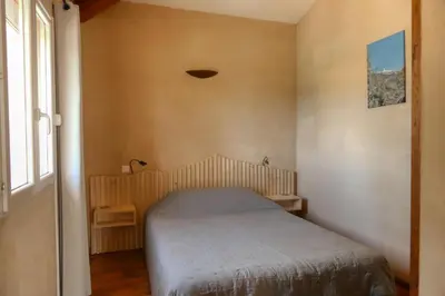 a small bedroom with a bed and a window at Villa jeanne avec piscine Chauffée à Bedoin in Bédoin