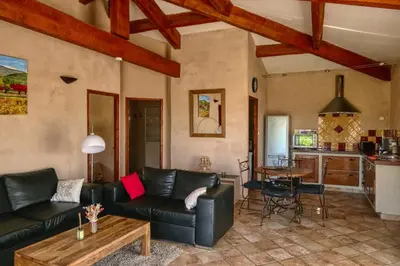 a living room with a couch and a table at Villa jeanne avec piscine Chauffée à Bedoin in Bédoin