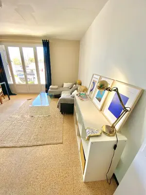 a living room with a table and a couch at Charmant Appartement Proche Centre Balcon Belle Vue Cathédrale in Aix-en-Provence