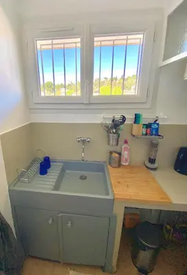 a kitchen counter with a sink and a window at Charmant Appartement Proche Centre Balcon Belle Vue Cathédrale in Aix-en-Provence