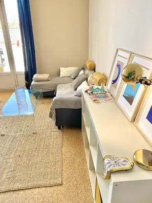 a living room with a couch and a table at Charmant Appartement Proche Centre Balcon Belle Vue Cathédrale in Aix-en-Provence
