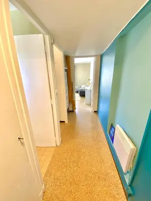 a hallway with a white refrigerator and blue walls at Charmant Appartement Proche Centre Balcon Belle Vue Cathédrale in Aix-en-Provence