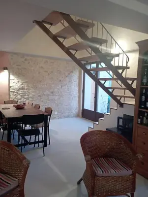 a dining room with a table and a staircase at Maison de campagne La Teranga au coeur du Luberon in Apt
