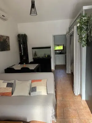 a living room with a white couch and a television at La Port-Gentillaise in Aix-en-Provence