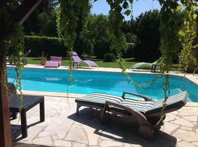 a swing in front of a swimming pool at La Port-Gentillaise in Aix-en-Provence
