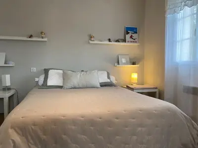 a bedroom with a bed and a window at PERNO LI FONT villa contemporaine avec piscine in Pernes-les-Fontaines