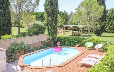 a swimming pool with a pink swan in a backyard at Les Romarins dans le Mas de la PERRINE entre AVIGNON LUBERON Mt VENTOUX in Monteux