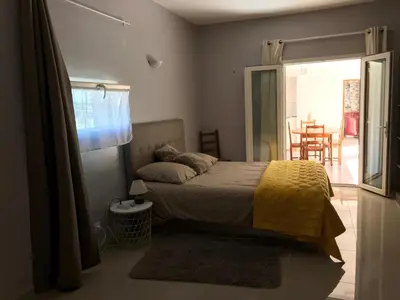 a bedroom with a bed with a yellow blanket at Maison au pied du mont ventoux in Carpentras