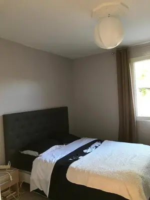 a bedroom with a large bed and a window at Maison au pied du mont ventoux in Carpentras