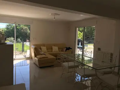 a living room with a couch and a glass table at Maison au pied du mont ventoux in Carpentras