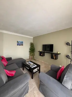 a living room with two couches and a tv at Les Juliens in Gordes