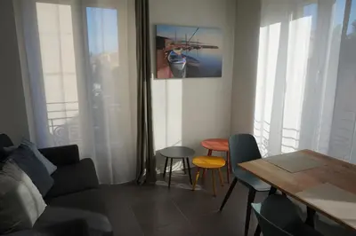 a living room with a couch and a table at Appartement Suite Privilège avec Parking in Salon-de-Provence
