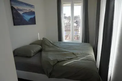 a bed in a room with a window at Appartement Suite Privilège avec Parking in Salon-de-Provence