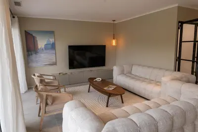 a living room with a couch and a tv at Comme à la maison in Châteauneuf-de-Gadagne