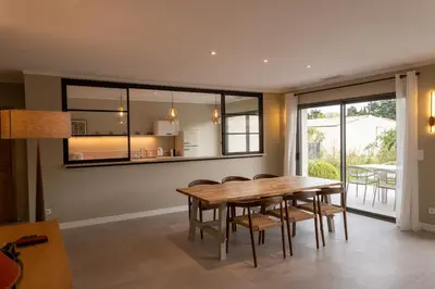 a dining room with a wooden table and chairs at Comme à la maison in Châteauneuf-de-Gadagne
