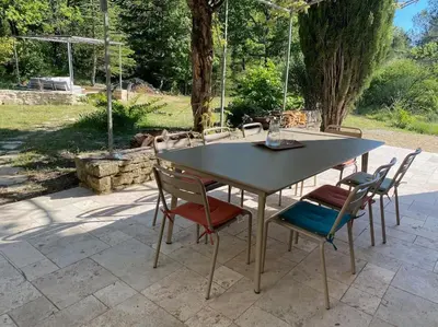 a table and chairs sitting on a patio at Magnifique Mas avec Piscine Luberon (Gordes) in Murs