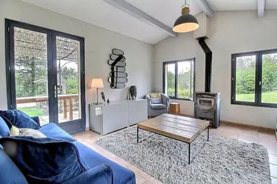 a living room with a blue couch and a table at Mazet avec piscine, vue Ventoux in Crillon-le-Brave